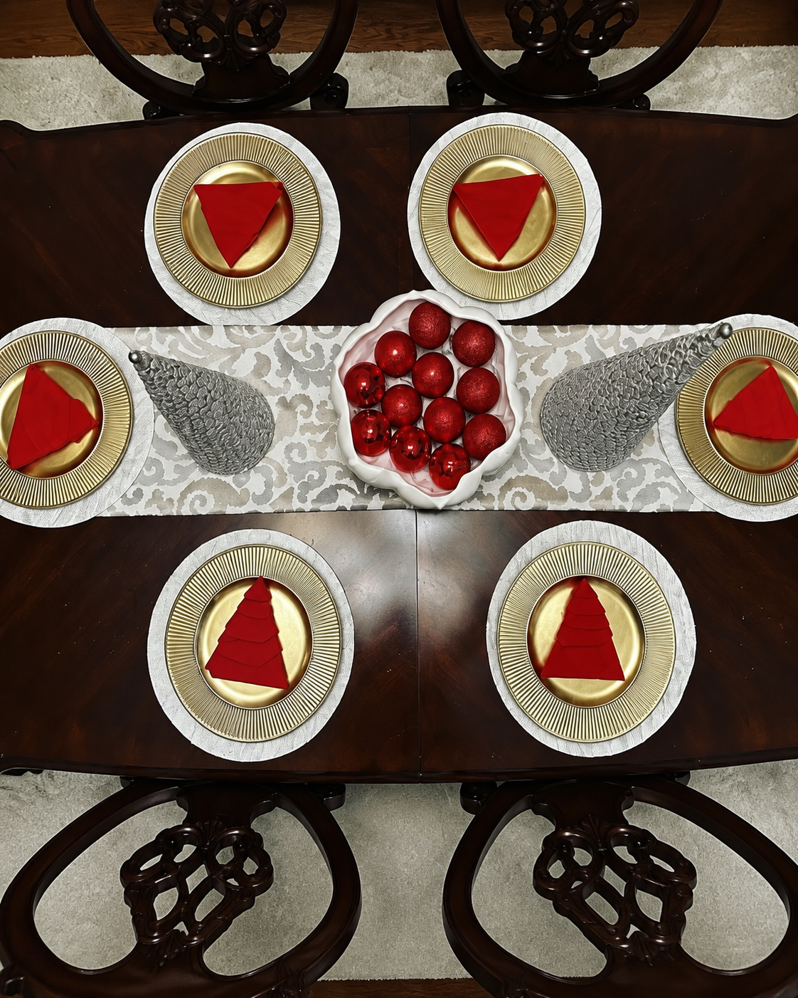 Christmas table with red napkins and gold plates