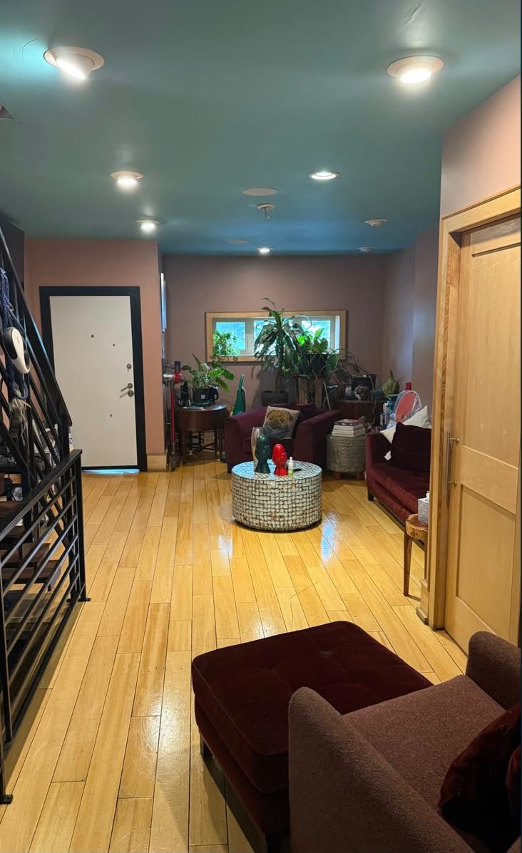 The same living room tidy with clear polished hardwood floors after cleaning