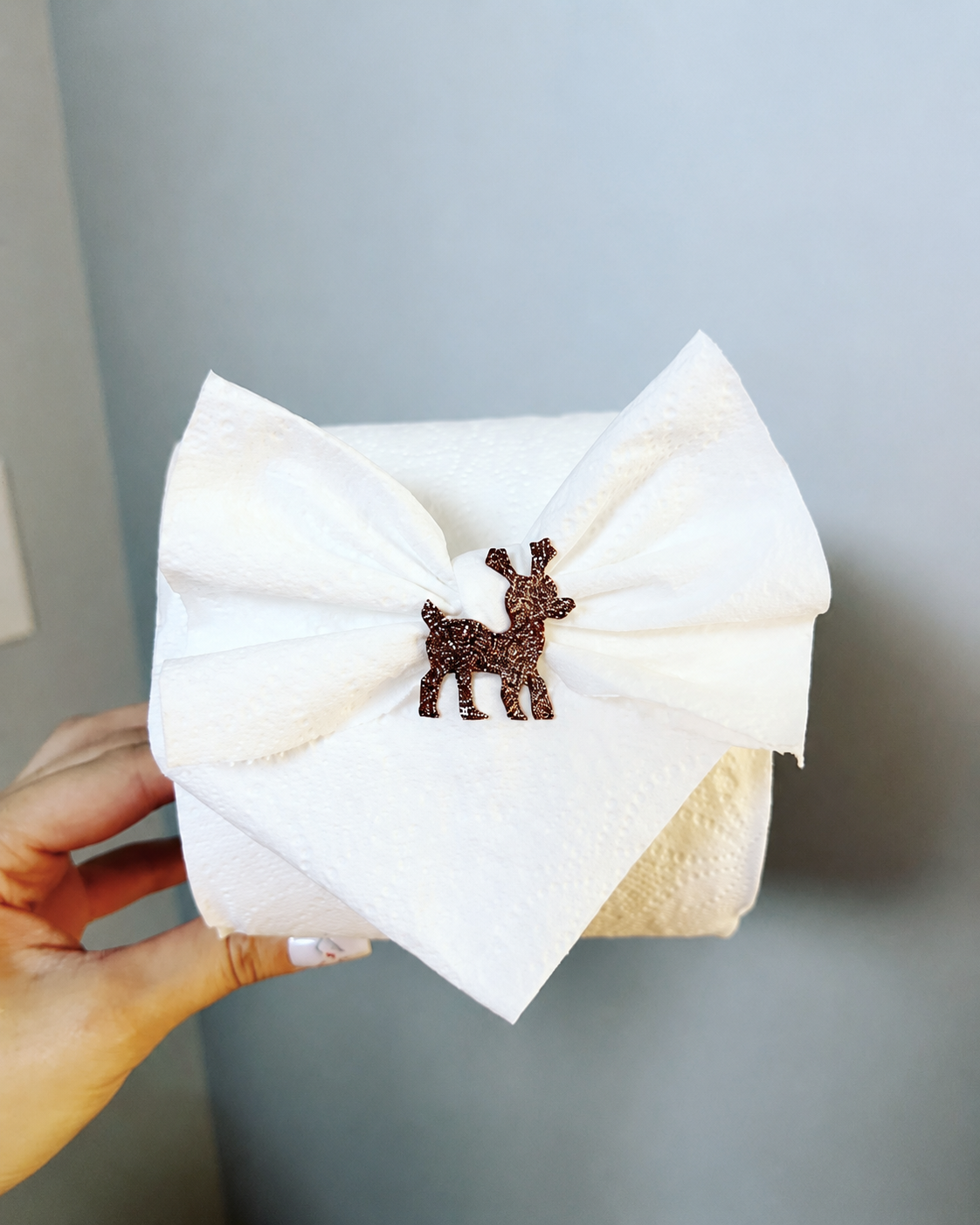 White paper bow with a small reindeer decoration