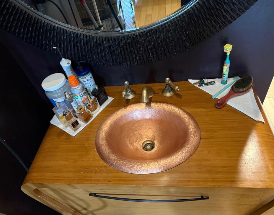 The same vanity cleared and the copper sink polished after deep cleaning